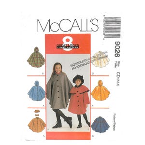 May include: McCall's sewing pattern featuring children's capes in various colors and styles. The pattern includes a red and orange graphic with the text "GREAT LOOKS 1 EASY PATTERN". The pattern number is 9026, size CD (2,3,4).