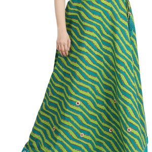 May include: A long green skirt with a red and white chevron pattern and small white flowers. The skirt has a teal blue trim and a tassel tie.