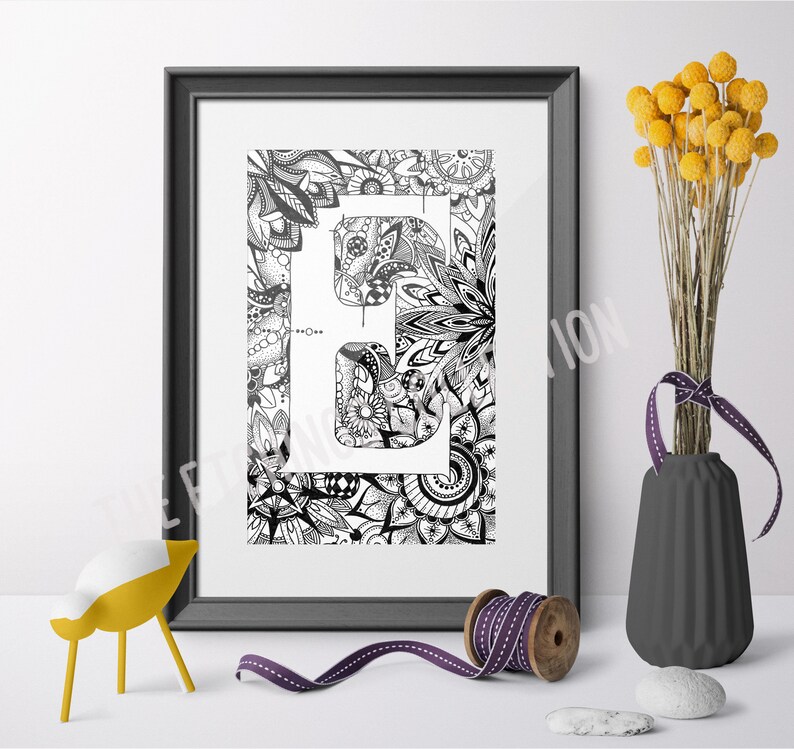 May include: Black and white printable art print featuring the letter "E" surrounded by intricate floral designs. The letter is white and the background is black.