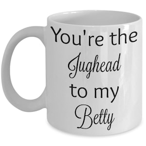 May include: White ceramic coffee mug with black text that reads "You're the Jughead to my Betty".