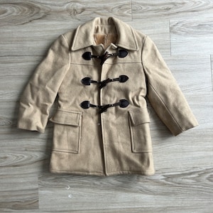 May include: A beige wool coat with a brown fur lining and brown leather toggle closures.