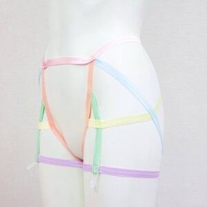 May include: A set of pastel colored garters with a criss-cross design. The garters are made of a soft, stretchy material and are adjustable to fit most sizes.