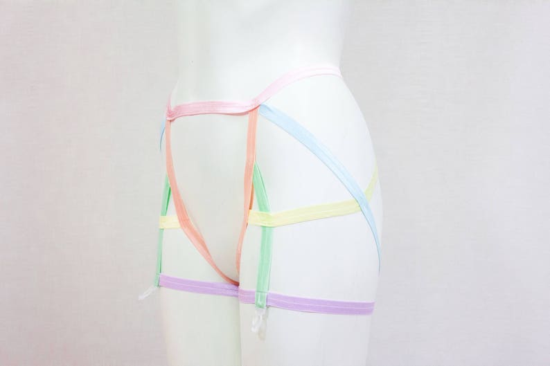 May include: A set of pastel colored garters with a criss-cross design. The garters are made of a soft, stretchy material and are adjustable to fit most sizes.