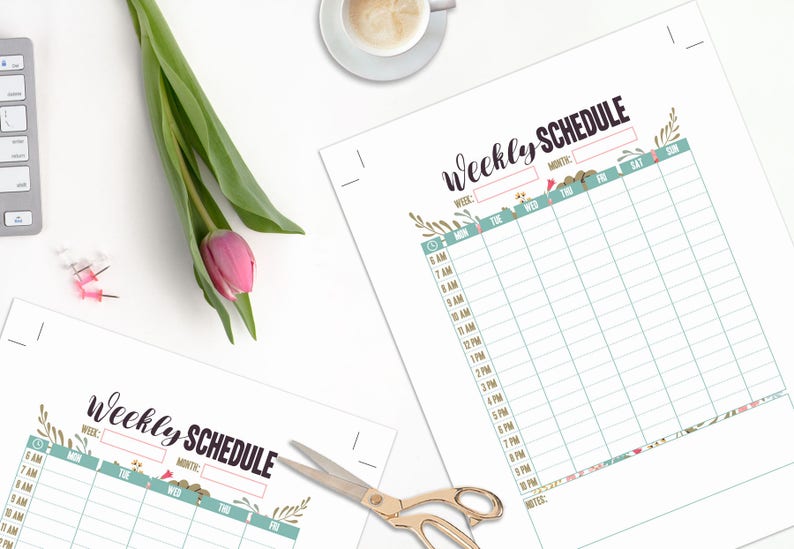 May include: Two printed weekly schedule sheets with floral accents and the text "Weekly Schedule". A pink tulip and green leaves are next to the sheets. A cup of coffee, a keyboard, and scissors are also visible.