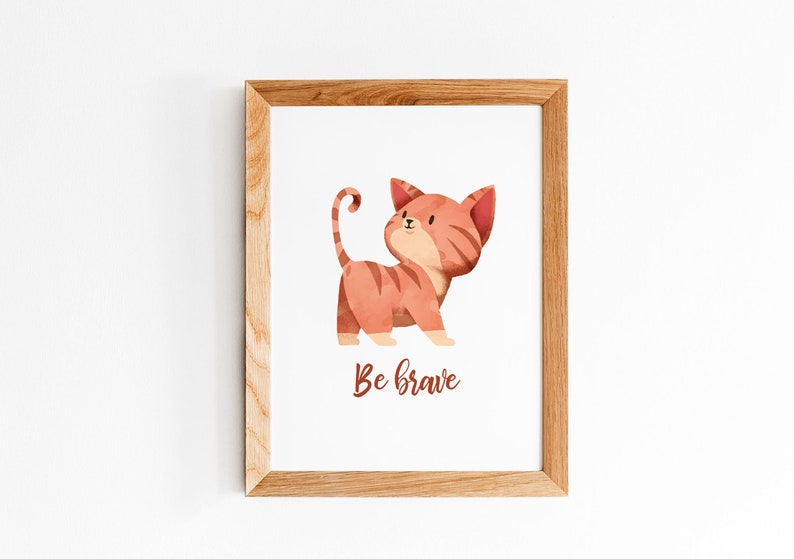 May include: A framed print with a watercolor illustration of a red and orange cat with the text "Be brave" underneath.