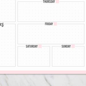 May include: A white weekly planner with a pink border and pink accents. The planner includes sections for each day of the week, with the days of the week labeled in pink. There is a section for notes and a dotted grid.