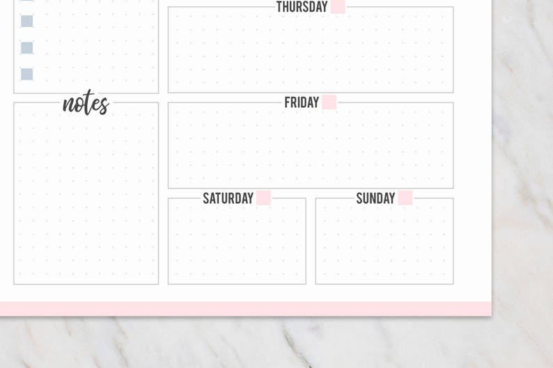 May include: A white weekly planner with a pink border and pink accents. The planner includes sections for each day of the week, with the days of the week labeled in pink. There is a section for notes and a dotted grid.