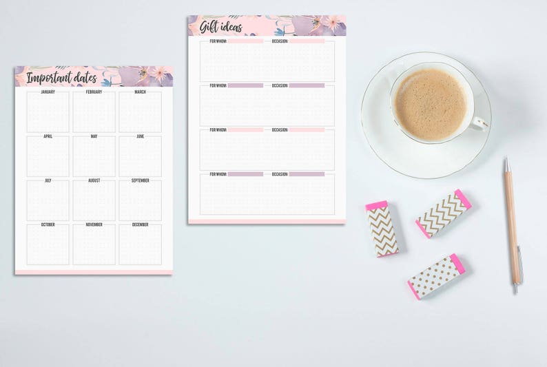 May include: Two notepads with floral accents and text reading "Important Dates" and "Gift Ideas." A cup of coffee, a pencil, and three patterned erasers are also on the white surface. The notepads have pink and purple borders.
