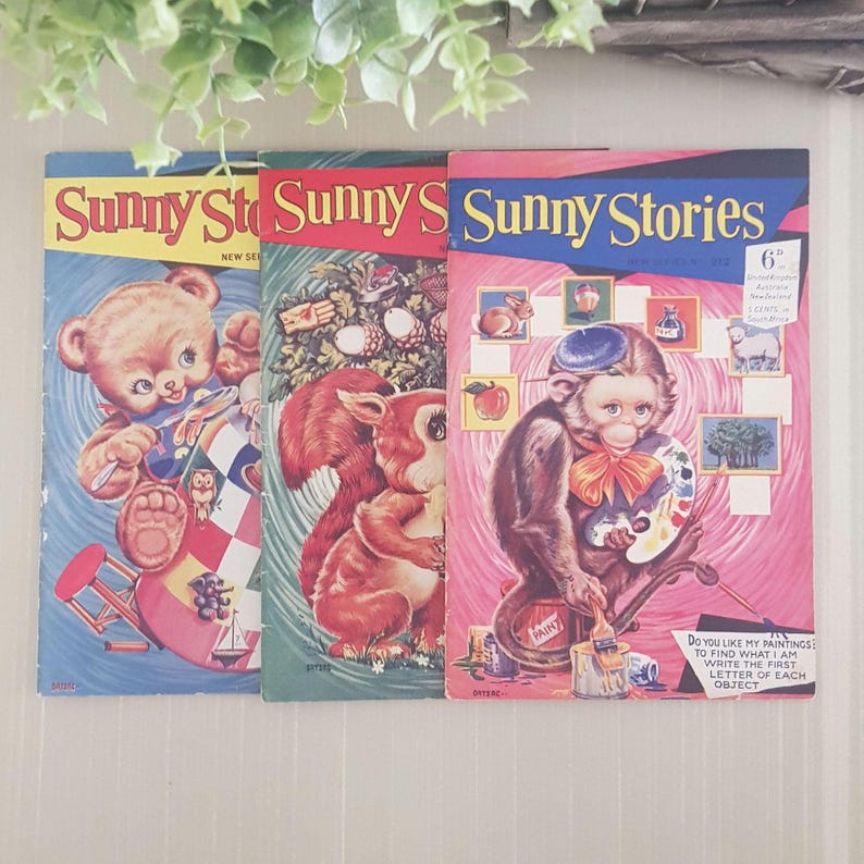 Three vintage children's activity books with colorful covers. The covers feature a bear, a squirrel, and a monkey, each holding a paintbrush and palette. The books are titled "Sunny Stories" and have a price of 6 pence.