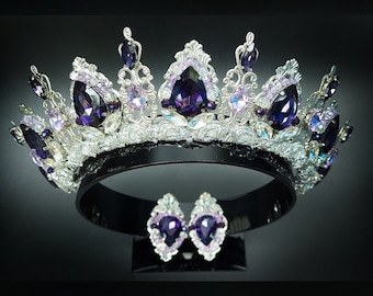 May include: A silver tiara with purple and clear gemstones, and a pair of matching earrings with purple gemstones.