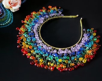 May include: A rainbow headband with a gold wire base and colorful glass beads. The beads are arranged in a cascading pattern, creating a rainbow effect.