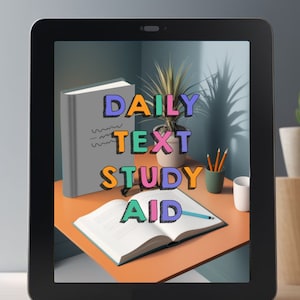 May include: A tablet screen displaying a digital illustration of a desk with a book, a plant, and a cup. The text "DAILY TEXT STUDY AID" is displayed in colorful, outlined letters.