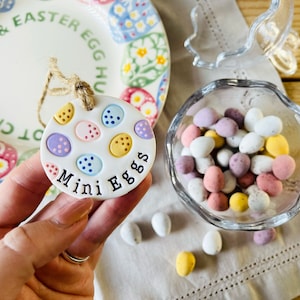 May include: White ceramic Easter egg ornament with colourful polka dots and the text "Mini Eggs".