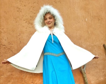 Turquoise/teal cape with false fur surrounding the hood.Style cosplay, fantasy, Victarian, elf, gothic, steampunk,medieval, celtic