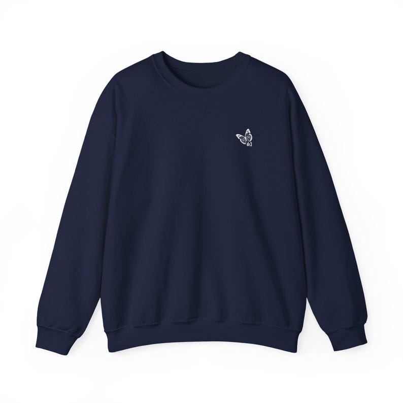 May include: A navy blue sweatshirt with a small white butterfly embroidered on the front.