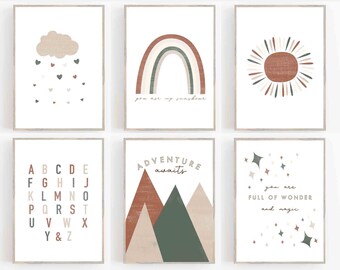May include: Six framed art prints with a neutral color palette. The prints feature illustrations of a cloud with hearts, a rainbow with the text "you are my sunshine", a sun, the alphabet, mountains with the text "adventure awaits", and stars with the text "you are full of wonder and magic".
