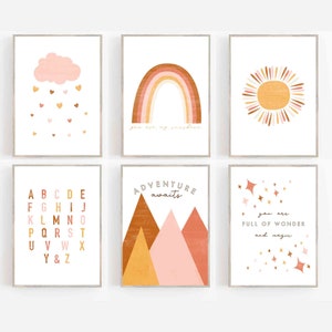 May include: Six framed art prints with a neutral color palette. The prints feature a cloud with hearts, a rainbow with the text "you are my sunshine", a sun, an alphabet, mountains with the text "adventure awaits", and stars with the text "you are full of wonder and magic".