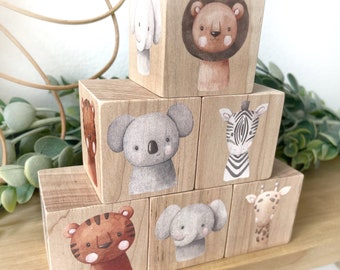 May include: A set of wooden blocks featuring different animals, including a lion, zebra, elephant, giraffe, tiger, and koala. Each block has a colorful illustration of the animal on one side.