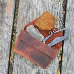 Flint and steel in leather pouch. image 1