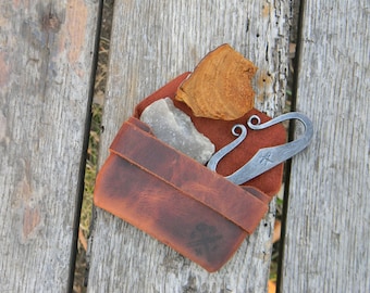 Flint and steel in leather pouch.