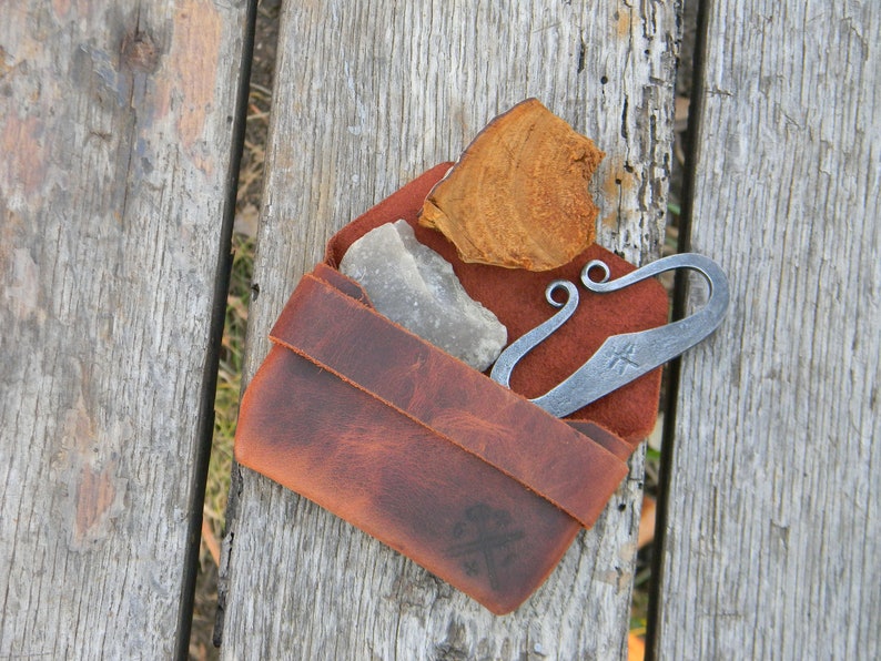 Flint and steel in leather pouch. image 1
