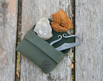 Flint and steel in leather pouch.