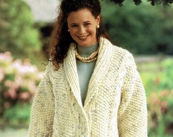 May include: A white knitted cardigan with a large collar, button fastening, and pockets. The cardigan is made with a textured yarn and has a subtle speckled pattern.