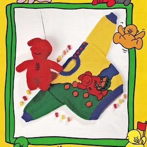 May include: A yellow, green, and blue knitted sweater with a red Jelly Baby character on the front. The sweater has a round neck and long sleeves. The sweater is surrounded by Jelly Baby characters and candy.