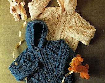 May include: Two knitted hooded cardigans for babies. One is blue with a cable knit pattern and the other is cream with a simple knit pattern.