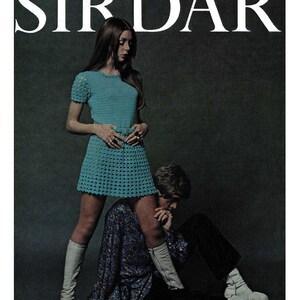 May include: A woman wearing a turquoise crochet dress and white boots stands with one leg on a man sitting on the floor. The man is wearing a black and white patterned shirt and white socks. The background is a dark gray. The text "SIRDAR" is printed in white at the top of the image.