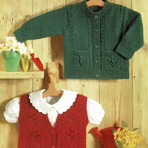 May include: Two knitted garments for children, a green cardigan with buttons and a red vest with a white collar. Both garments feature a cable knit pattern.