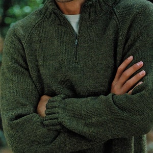 May include: A dark green knitted sweater with a zipper at the neck. The sweater has a ribbed collar and cuffs.