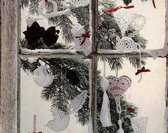 May include: A window with a snowy sill and a view of a Christmas tree decorated with crocheted ornaments. The ornaments are in the shape of birds, hearts, bells, and angels. The text "Lacey Victorian decorations are always at home on a Christmas Tree." is visible at the bottom of the image.