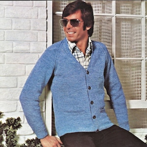May include: A blue knitted cardigan with a v-neck and button closure. The cardigan has two pockets and is worn over a plaid shirt.