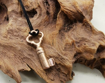 Solid bronze key pendant - hand made, hand cast and beautifully finished with a cord. Weighs 6.2 grams.