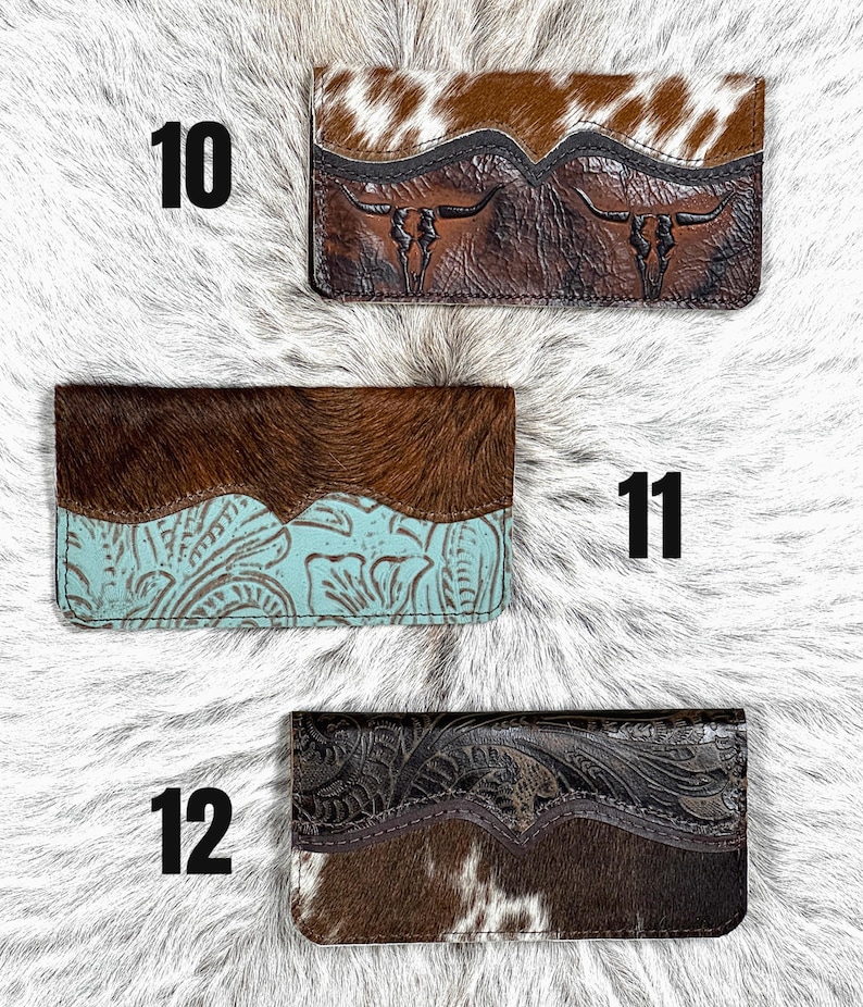 May include: Three rectangular wallets labeled 10, 11, and 12. Wallet 10 features brown and white cowhide with embossed longhorn skulls. Wallet 11 has dark brown cowhide and turquoise embossed leather. Wallet 12 displays dark embossed leather and brown cowhide.