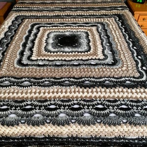 Hand-crocheted king-size blanket in a German shell design, Day blanket. Crocheted with colors black, beige, and grey wool, 101 by 101 inches