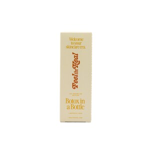 May include: A rectangular skincare product box in a cream color. The box features the text "Welcome to your skincare era." and "Feel the Heal" in a stylized font. Below, it reads "Botox in a Bottle."