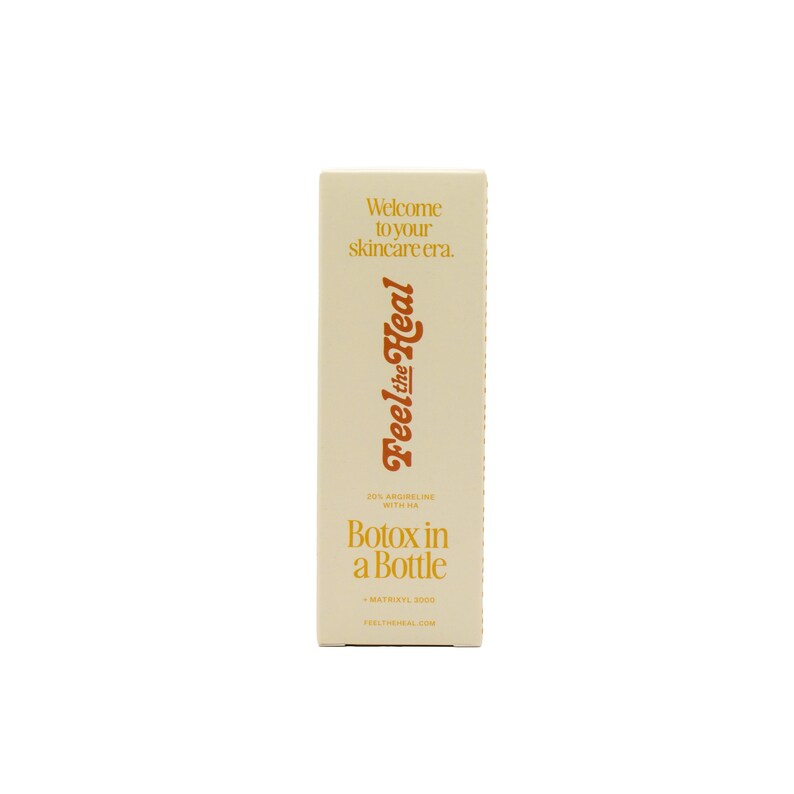 May include: A rectangular skincare product box in a cream color. The box features the text "Welcome to your skincare era." and "Feel the Heal" in a stylized font. Below, it reads "Botox in a Bottle."