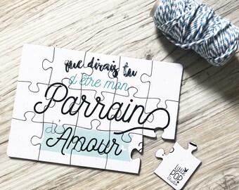 May include: White jigsaw puzzle with the text "que dirais tu d'etre mon Parrain d'Amour" in black and blue lettering. The puzzle is partially assembled and the missing piece has the text "Little POP Studio" on it.