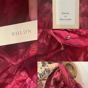 May include: A close-up of a pink garment with a textured pattern. The garment has small gold-colored buttons and a tag that reads "BHLDN". The tag also displays the size "M" and the color "PINK COMBO".