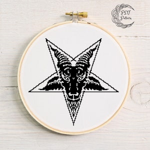May include: Black and white cross stitch pattern of a goat's head inside a pentagram. The pattern is in a round embroidery hoop.