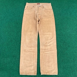 May include: A pair of light brown denim jeans with a straight leg fit. The jeans have a button fly and five pockets.