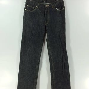 May include: A pair of dark blue denim jeans with a straight leg fit. The jeans have a button fly and belt loops.