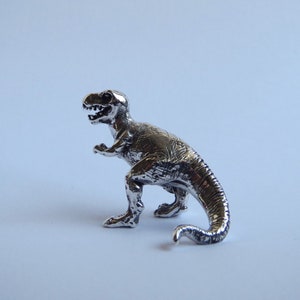 silver T. rex dinosaur figurine