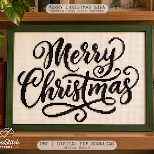 May include: A counted cross stitch pattern featuring the black text Merry Christmas in a cursive script on white Aida fabric. The design is displayed in a dark green rectangular frame, showcasing a clear and legible holiday message.