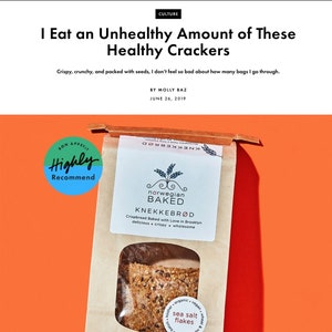 May include: A brown paper bag of Norwegian Baked Knekkebr&oslash;d crispbread with a clear window showing seeded crackers. The label features the text Norwegian Baked, Knekkebr&oslash;d, and sea salt flakes. A blue circular badge reads Bon App&eacute;tit Highly Recommend.
