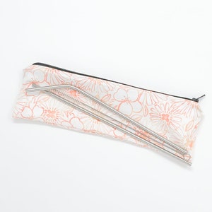 May include: A set of stainless steel drinking straws in a floral print carrying case. The case is white with a pink floral pattern.