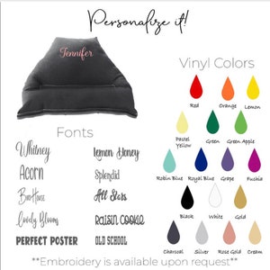 May include: A gray wedge pillow with a pocket for a book or tablet. The pillow is personalized with the name "Jennifer" in pink embroidery. The image shows a variety of fonts and vinyl colors to choose from for personalization.