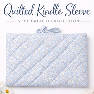 May include: A light blue quilted Kindle sleeve with a daisy floral pattern. The sleeve has a bow closure and is labeled "Quilted Kindle Sleeve" and "Soft Padded Protection". The case is designed to protect a Kindle device.